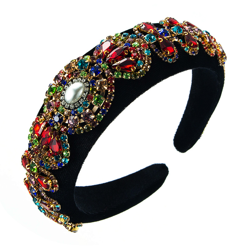 Dense rhinestones and faux pearl on black fabric
