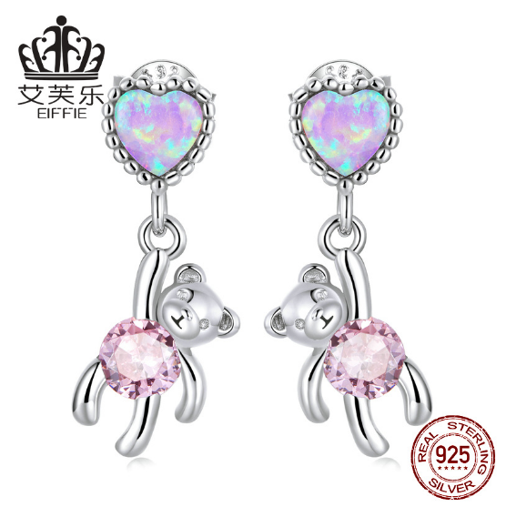 These earrings feature a unique design: a sterling silver heart shape with opal accents and a small bear engraved into the heart. Crafted from durable sterling silver, the earrings are finished with a bright polished shine and secure latch closure. Show off your style with this one-of-a-kind design and the long-lasting shine of sterling silver.