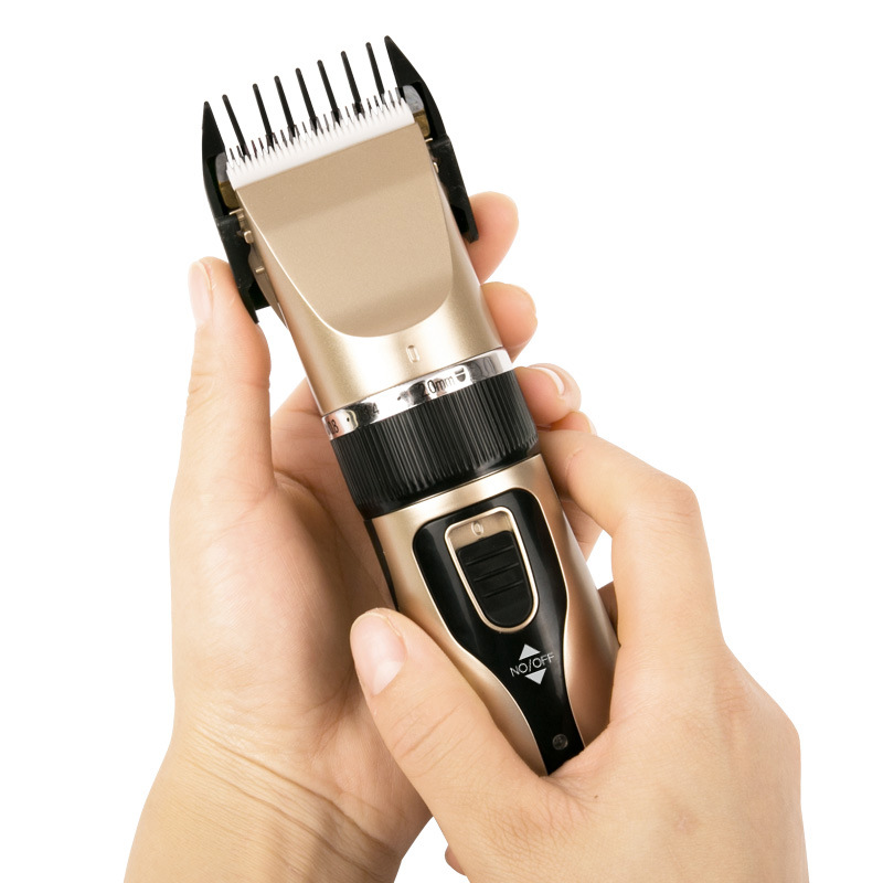 Clipper held with protective comb fitted over blade