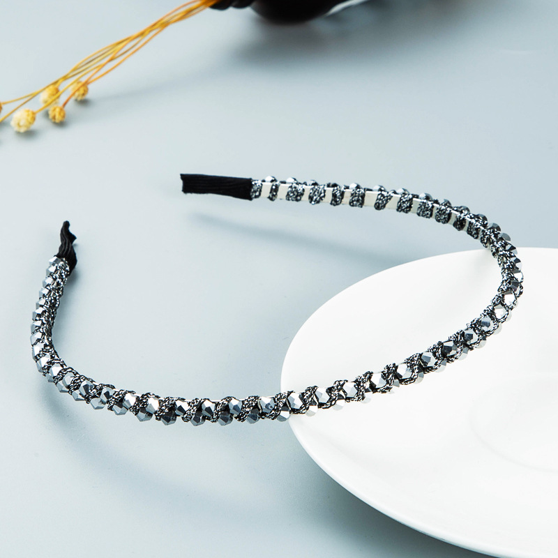 Silver headband with faceted crystals catching light
