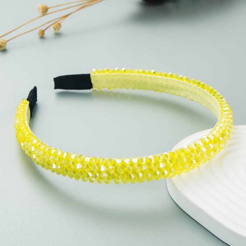 Close detail of faceted yellow braided beads