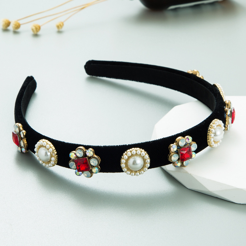 Pearl and red crystal clusters on black velvet