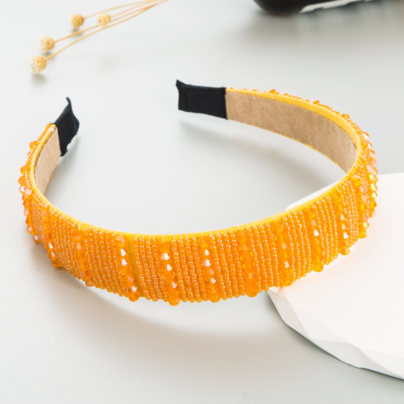Orange headband showing glossy faceted bead texture