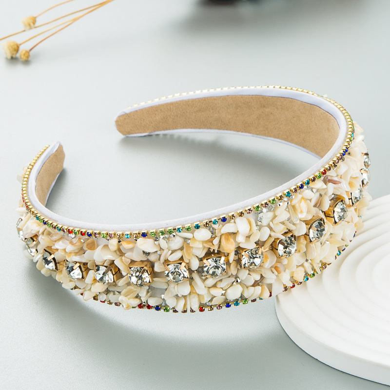 Cream padded headband with curved profile and layered trim