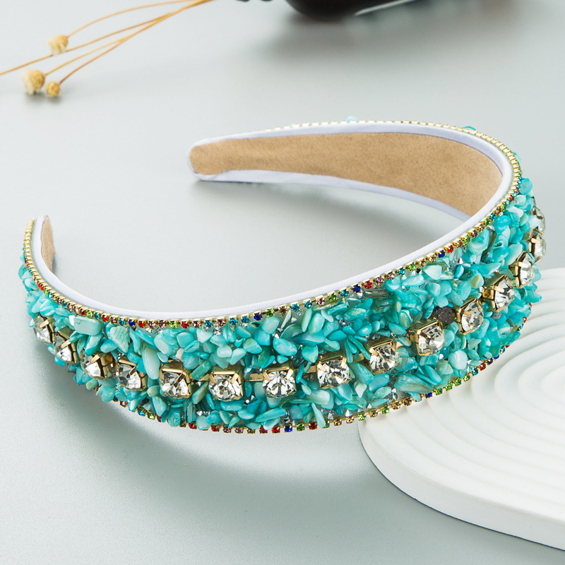 Close turquoise beadwork on a wide padded headband