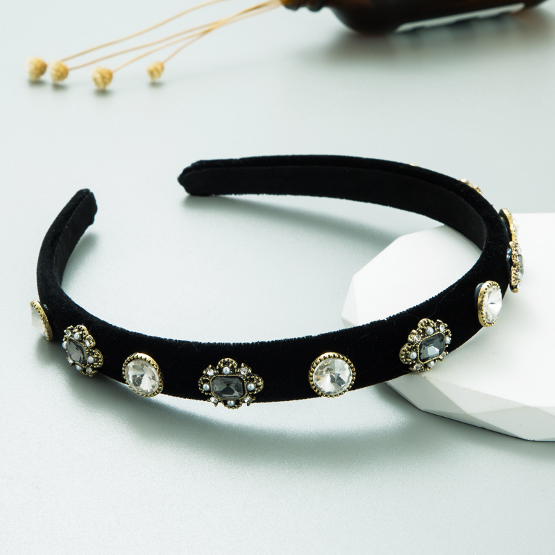 Padded black velvet headband on faceted pedestal