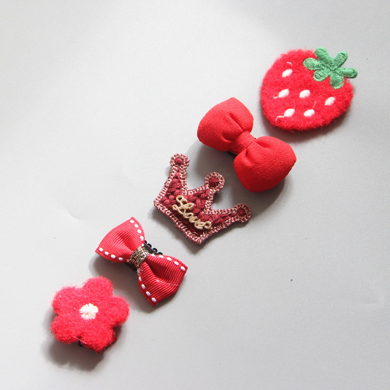 Red themed girls hair clips with crown and strawberry motifs