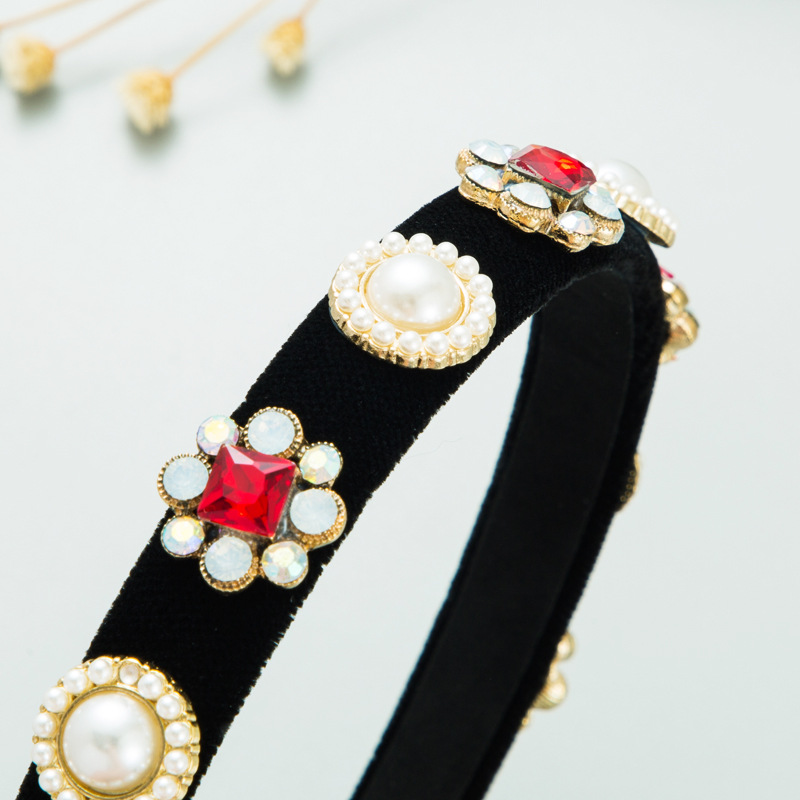 Macro view of ornate pearl and ruby embellishment