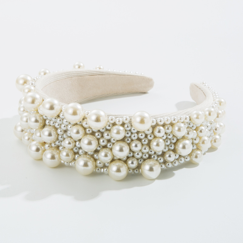 Angled view of wide padded pearl headband structure