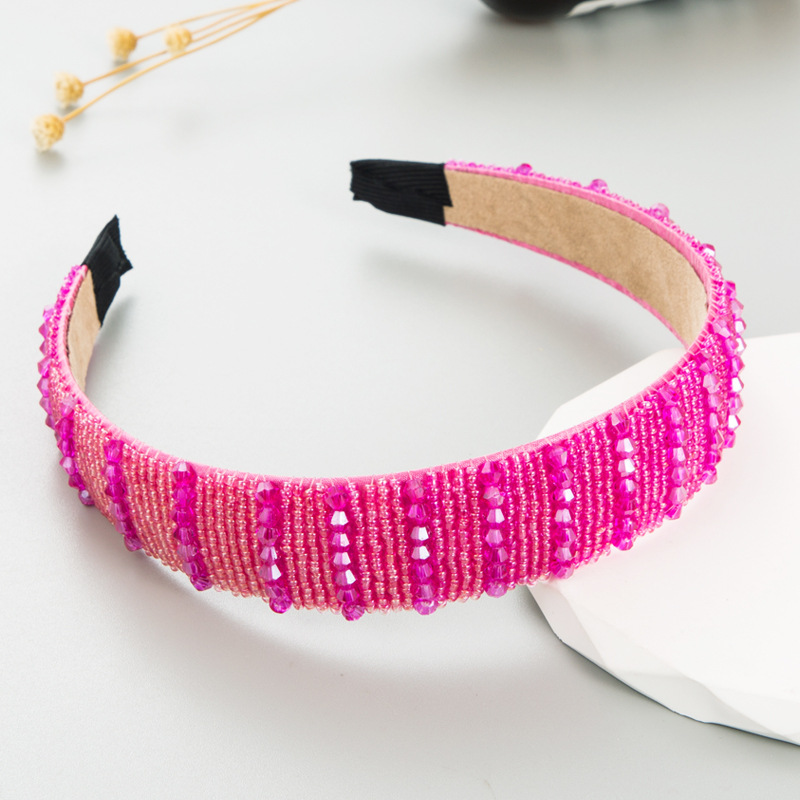 Pink beaded headband with beige lining and finished edges