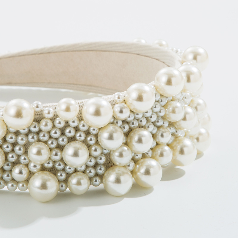 Glossy mixed-size pearls arranged in rounded clusters