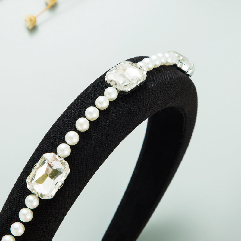 Macro view of pearl rows and clear rhinestones