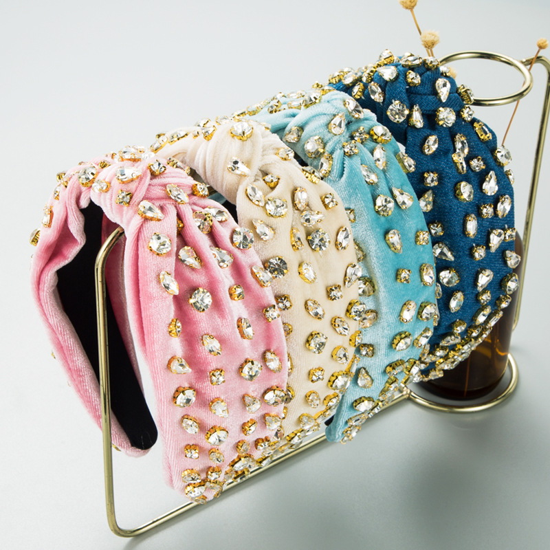Pastel rhinestone headbands on gold display stand