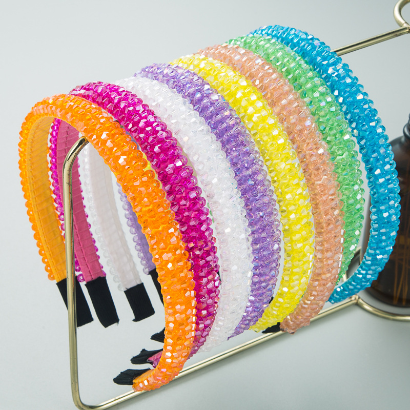 Assorted colorful crystal headbands on display stand