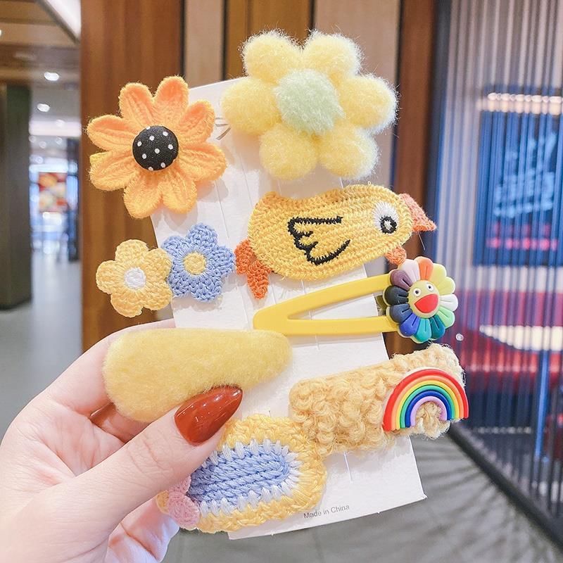 Assorted plush clips showing bows flowers and characters