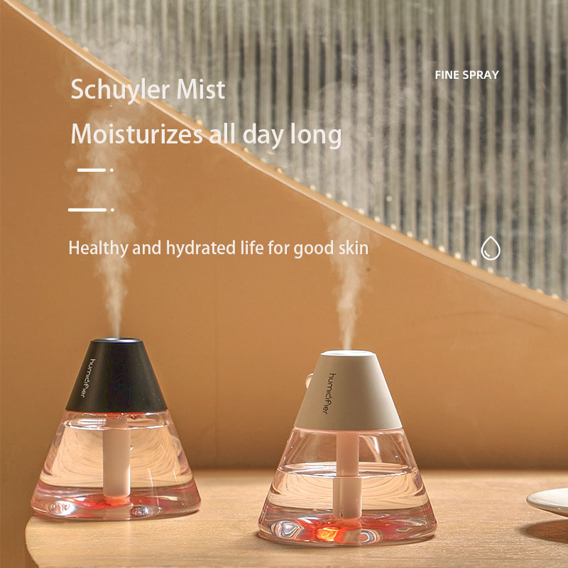 Two volcano humidifiers side‑by‑side, black and white caps, demonstrating fine mist and decorative appeal
