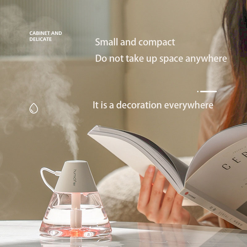 Hydration ritual at home: woman reads magazine beside misting volcano humidifier