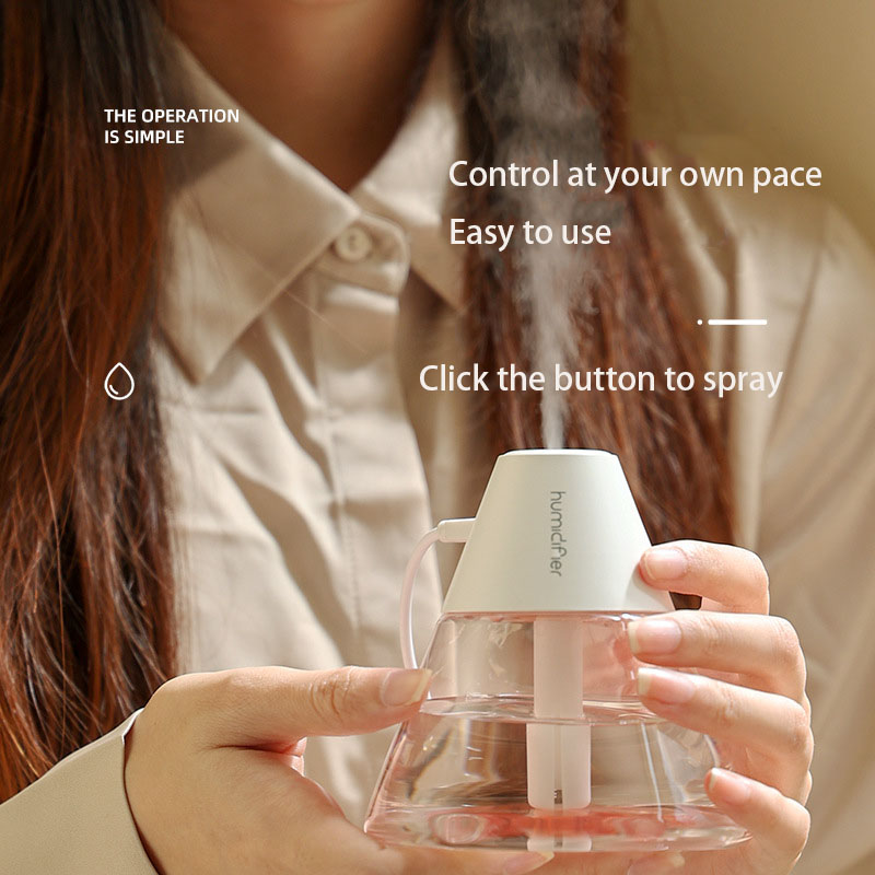 Woman demonstrates effortless one‑click button control on white-capped volcano humidifier