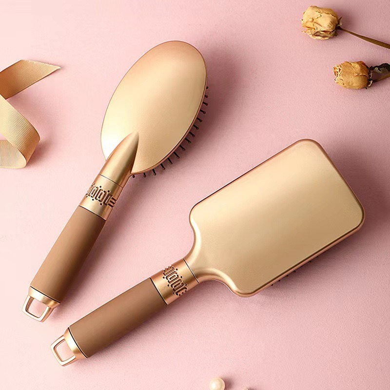 Close view of polished gold brush backs and handles