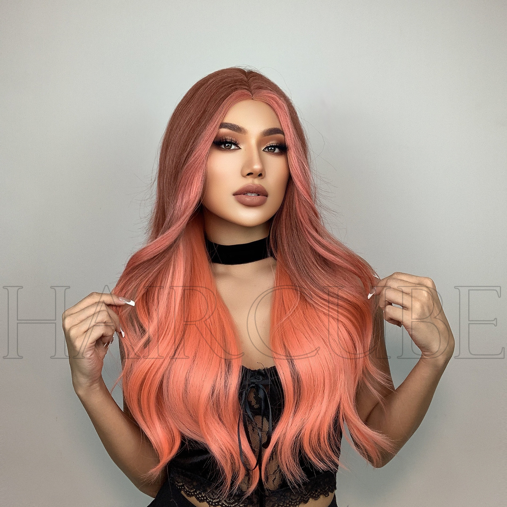 Front view of full long orange-pink wig waves