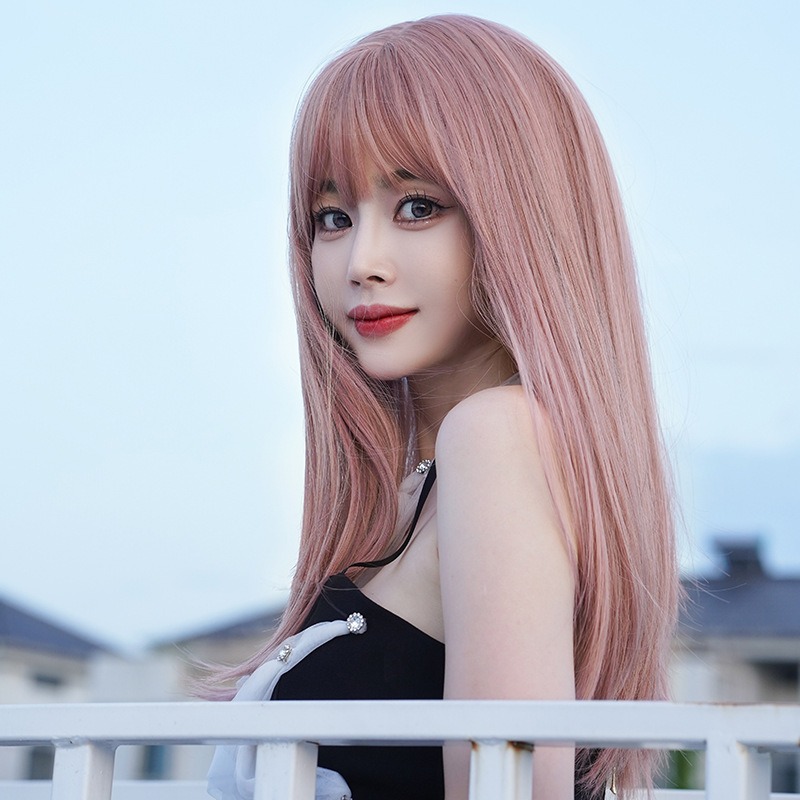 Soft pink air bangs framing a woman's face