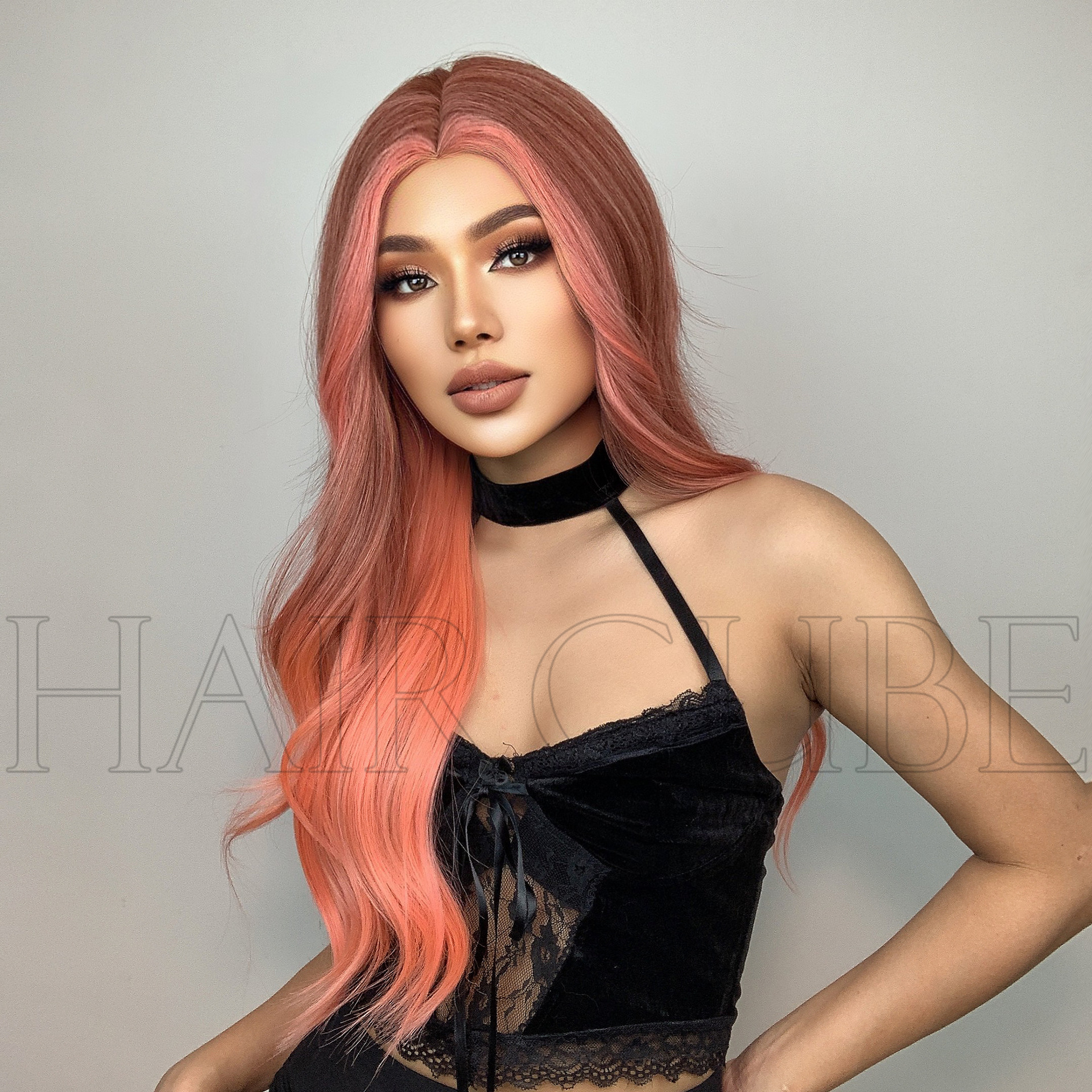 Three-quarter portrait with cascading orange-pink wig