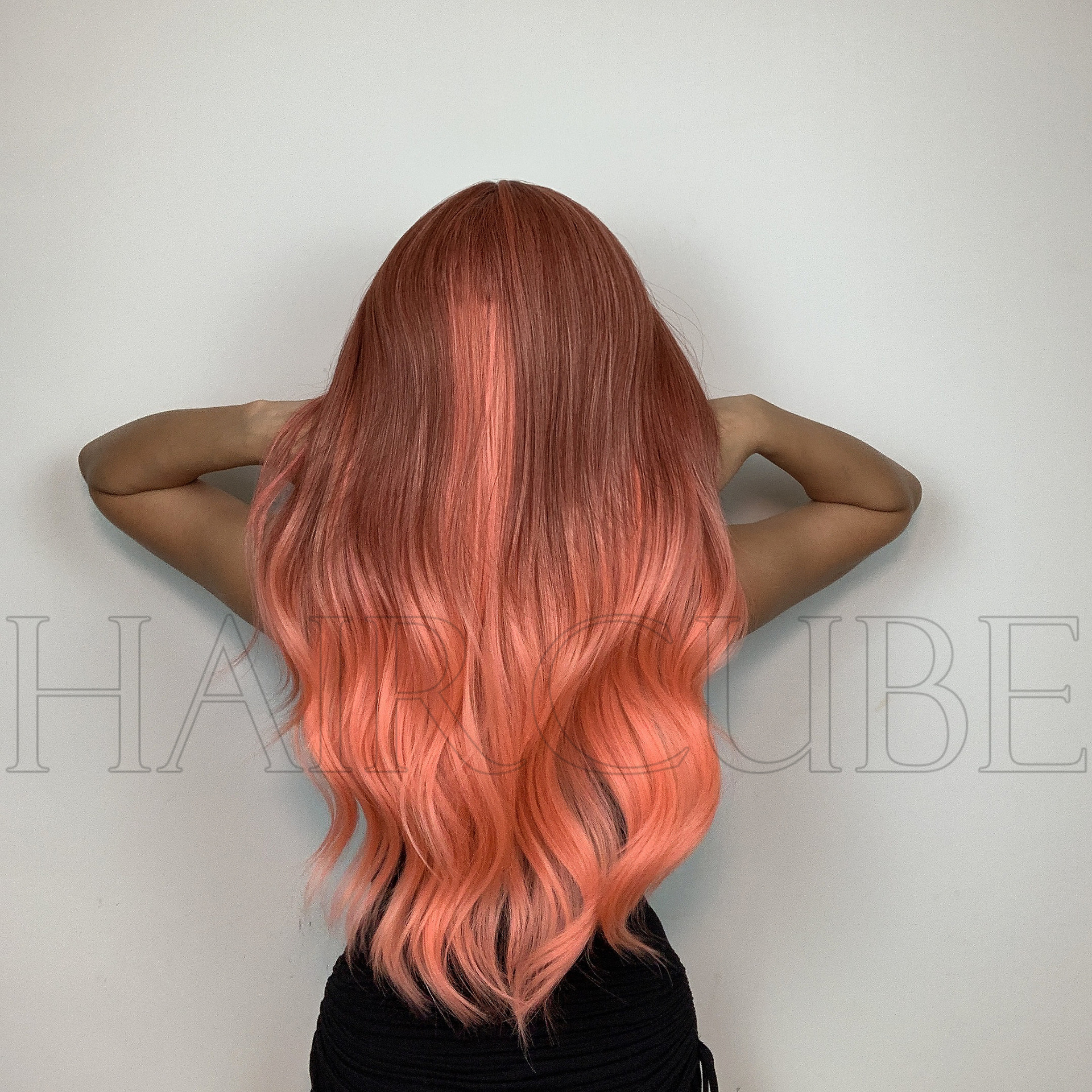 Rear view showing long layered orange-pink waves