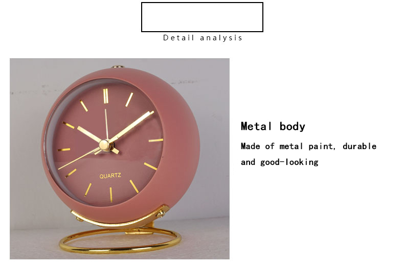 A pink alarm clock that is perfect for adding a pop of color to any bedroom.
