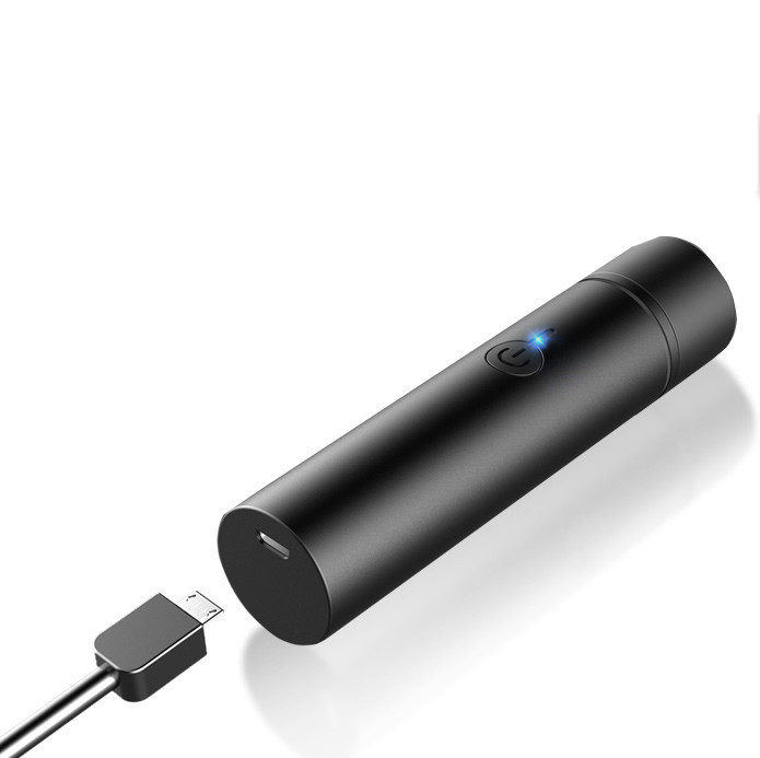Capped mini shaver beside included USB charging cable