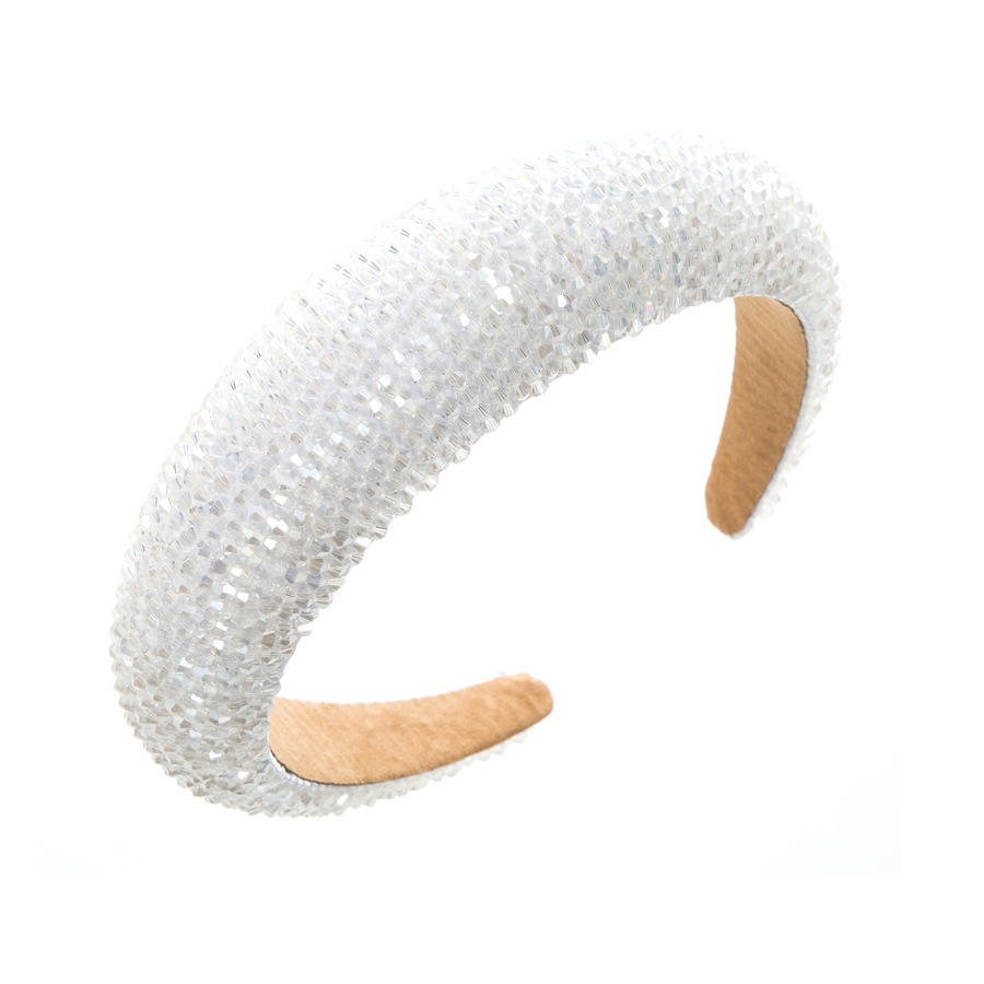 White wide padded headband showing its curved profile