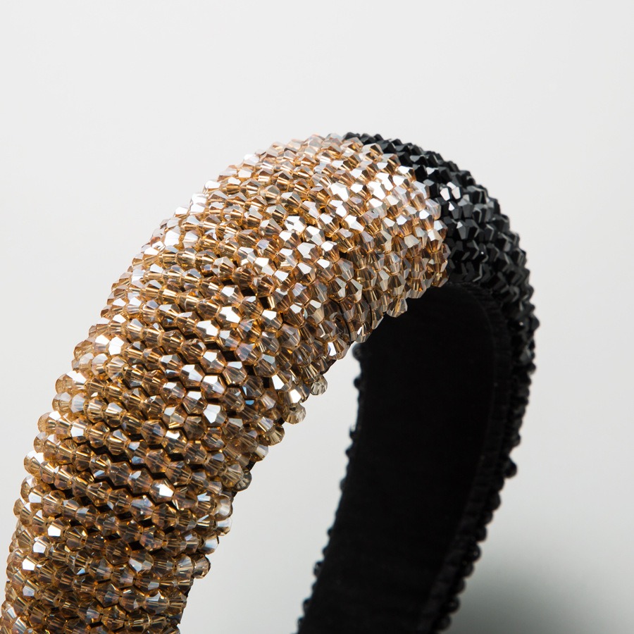 Close view of champagne faceted rhinestone headband surface