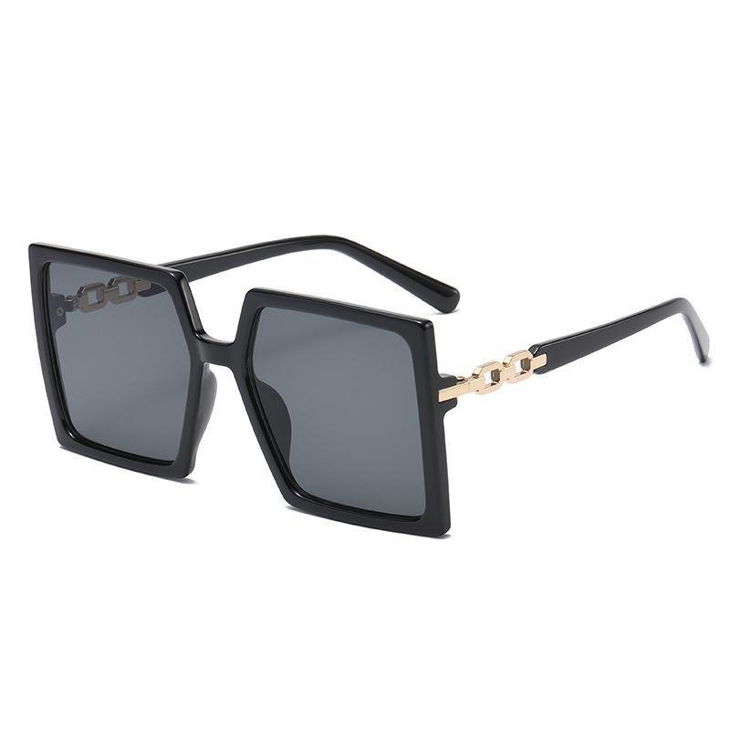 Black sunglasses with gold chain-style temple links