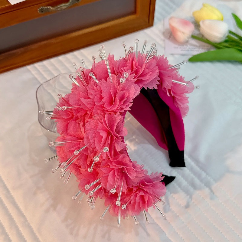 Hot pink headband showing layered floral volume