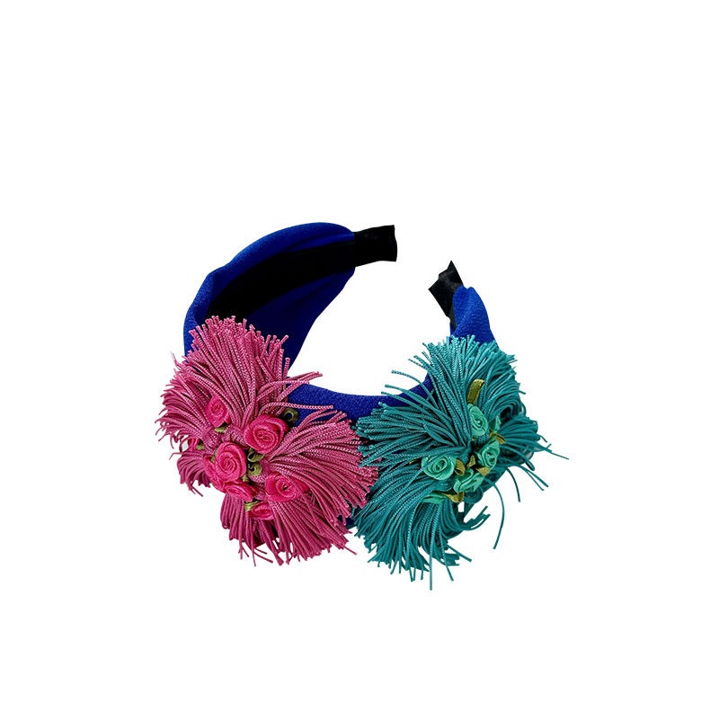 Royal blue headband showing rolled flower centers