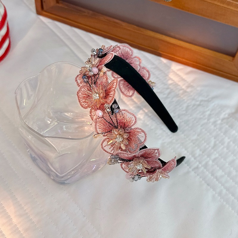 Floral black headband styled for polished hair