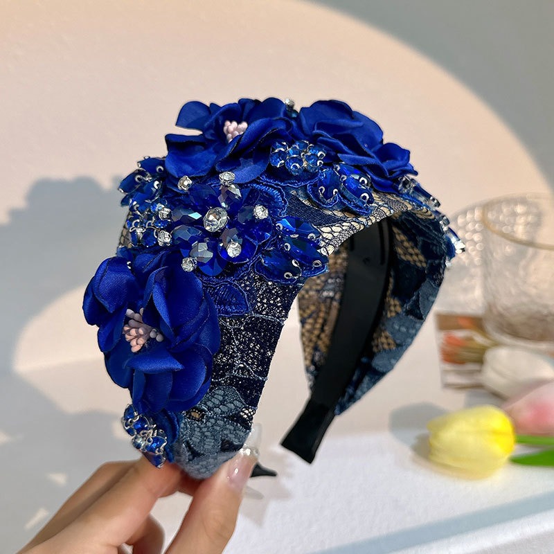 Blue headband showing layered flowers and lace texture