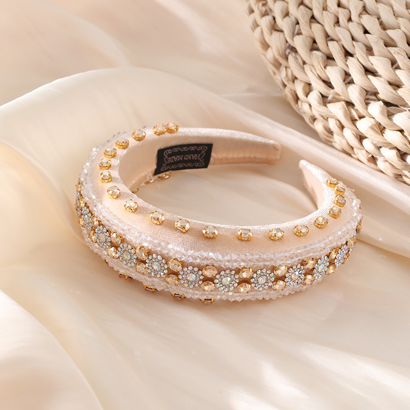 Cushioned fabric interior of an ornate embellished hair hoop
