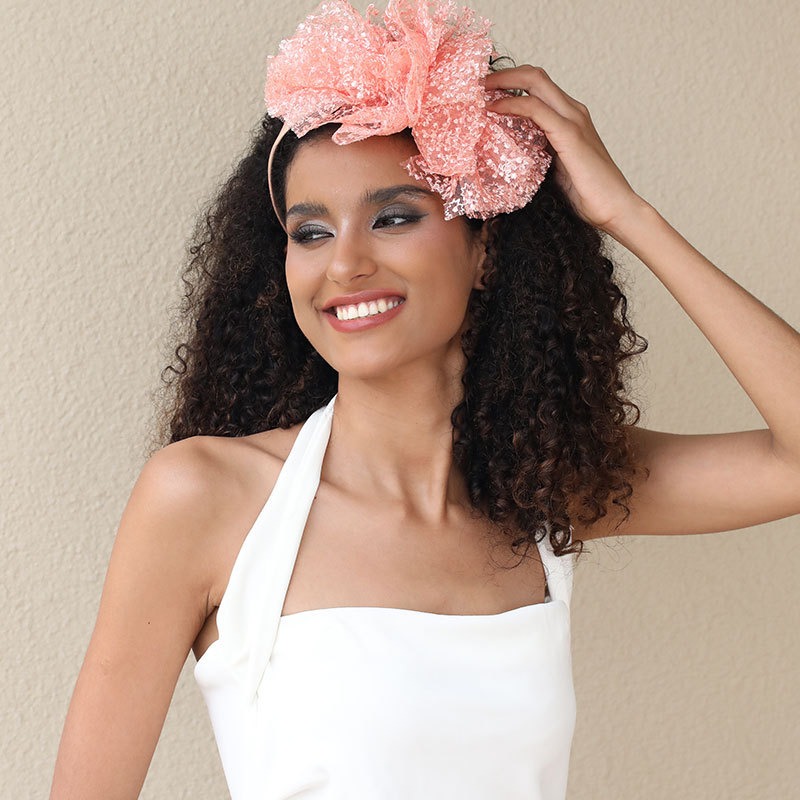 Structured headband worn securely with styled hair