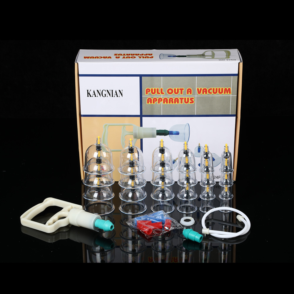 Professional cupping therapy set with 24 graduated glass cups, hand pump, magnetic inserts on brushed champagne metal surface