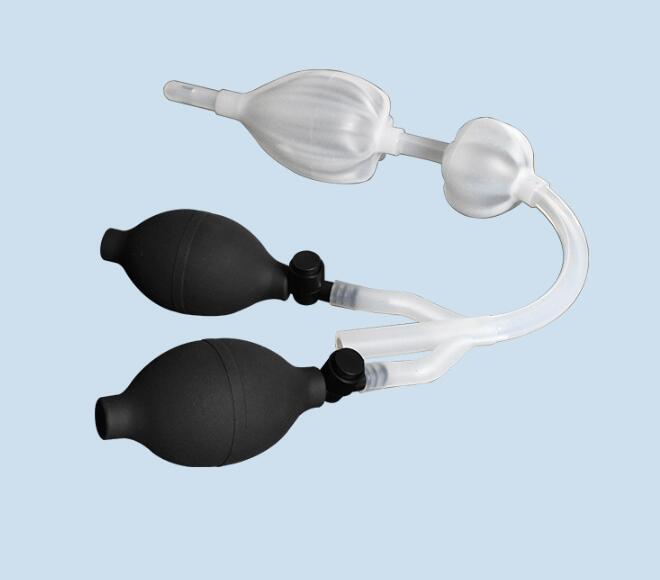 Close-up of black dual bulbs and clear inflated nozzle head on light blue background