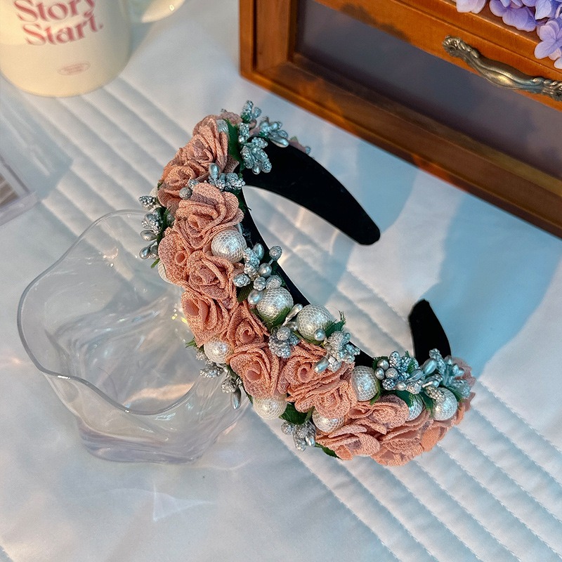 Blush embellished headband displayed in a romantic bedroom setting