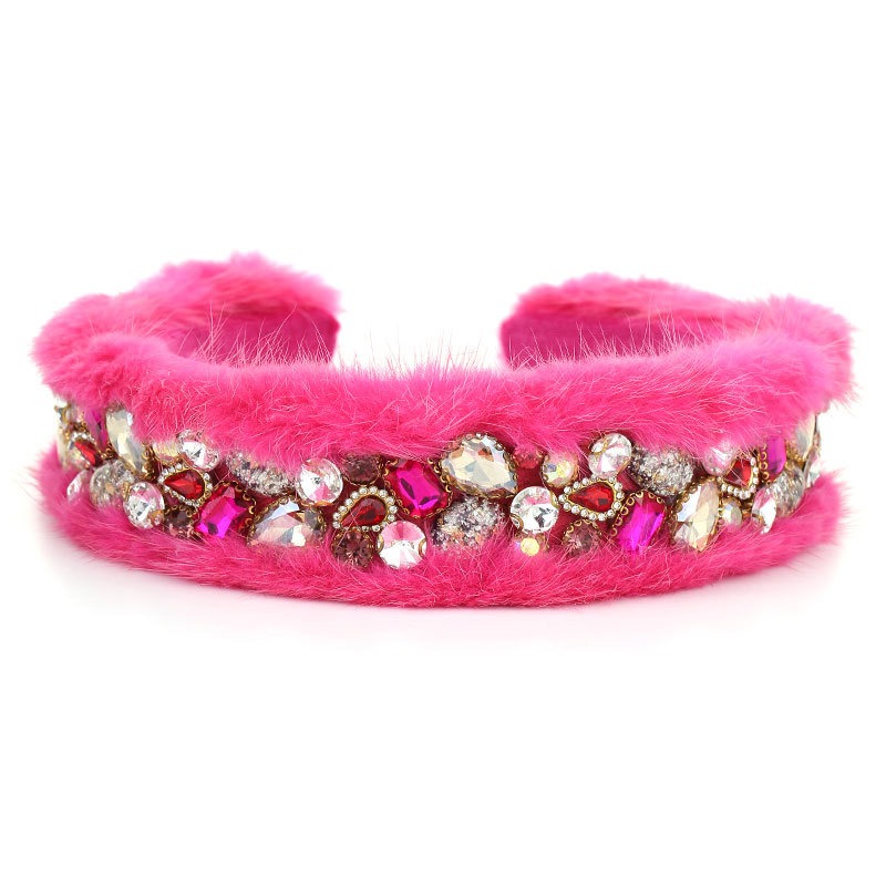 Pink fuzzy hoop close-up with crystal-like jewel accents