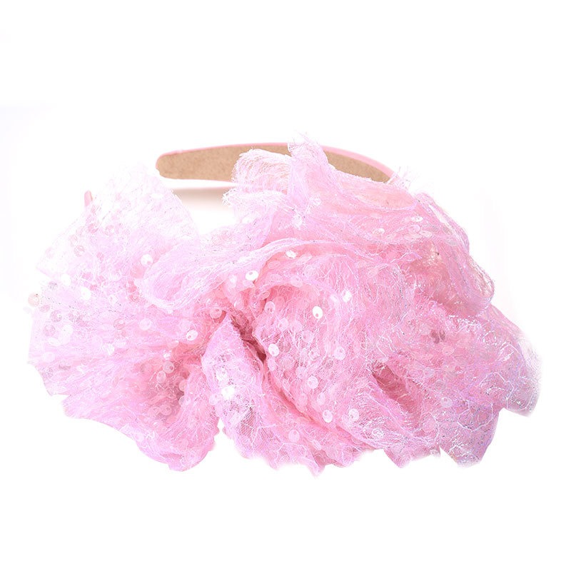 Blush pink oversized bow hairband styled close up