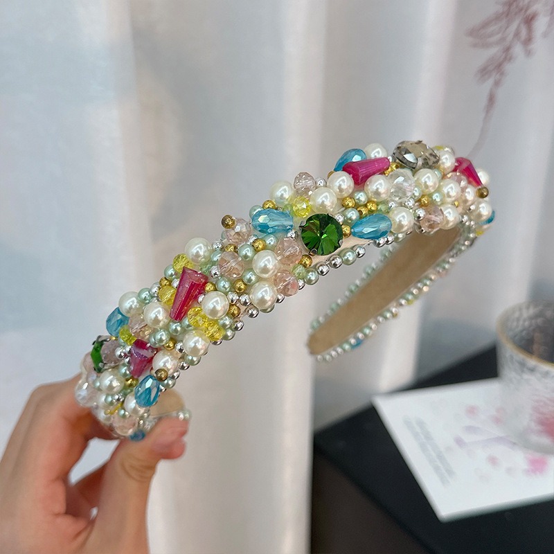 Jewel-toned headband with layered faux pearl embellishment