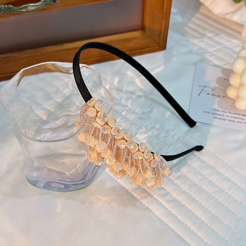 Champagne peach hoop with softly dangling decorative tassels
