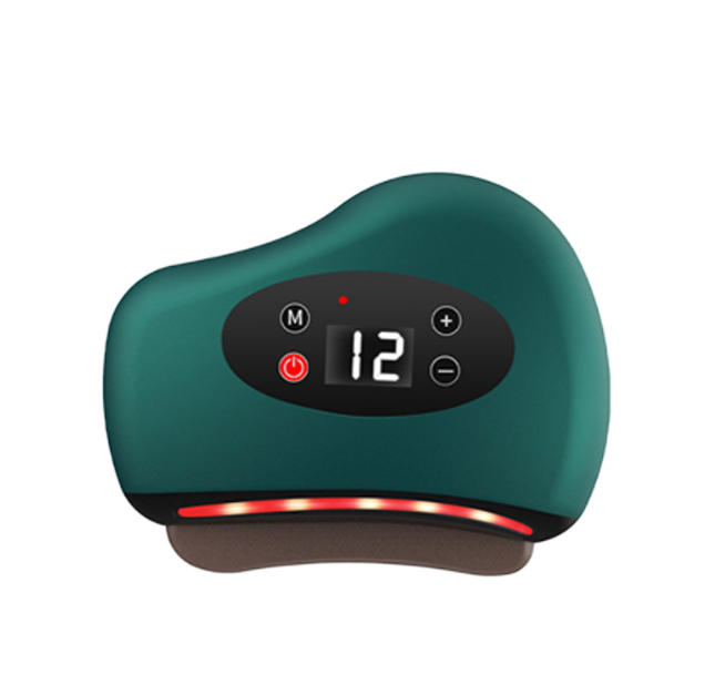 Matte teal electric guasha massager with digital temperature display, red LED accent, and curved bianstone scraping edge on light birch plywood backdrop