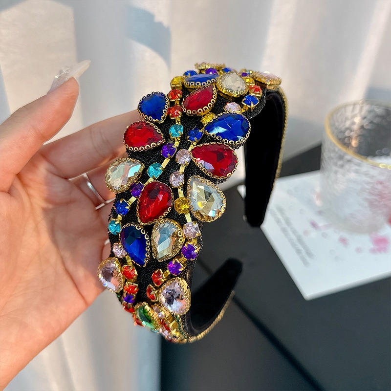 Angled jeweled headband with raised embellishments