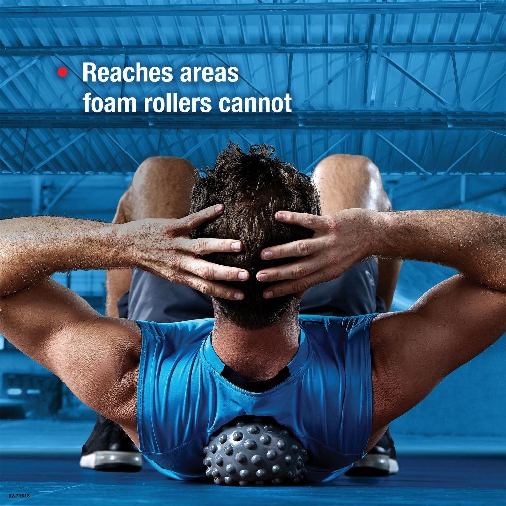 Athletic man using massage ball on neck while sitting in a bright room, with claim text 'Reaches areas foam rollers cannot'