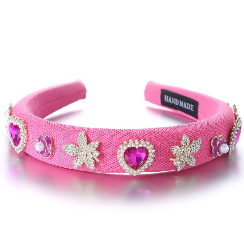 Pink embellished headband showing bold feminine styling