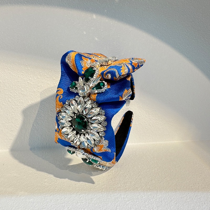 Wide padded hoop with ornate patterned fabric covering